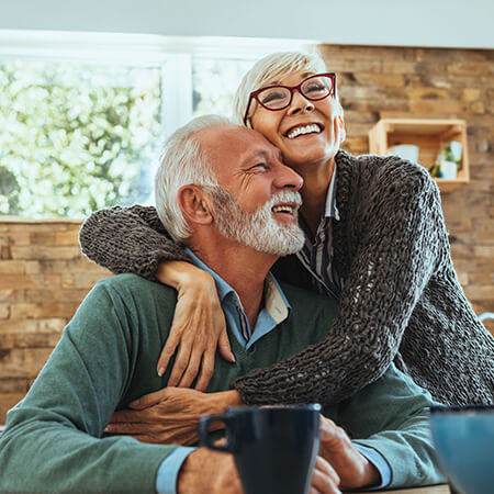 An older couple both with dental implants enjoying life